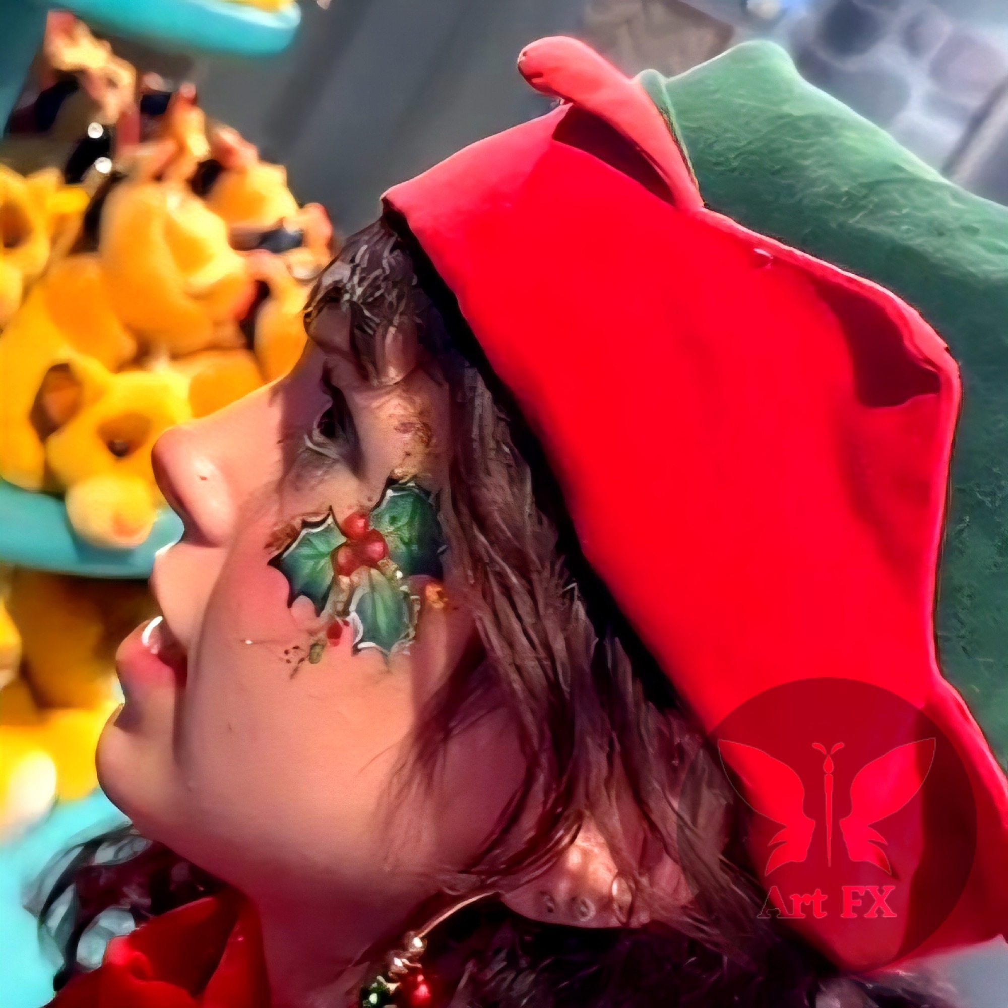 Holly and berries face paint on a person in an elf costume.