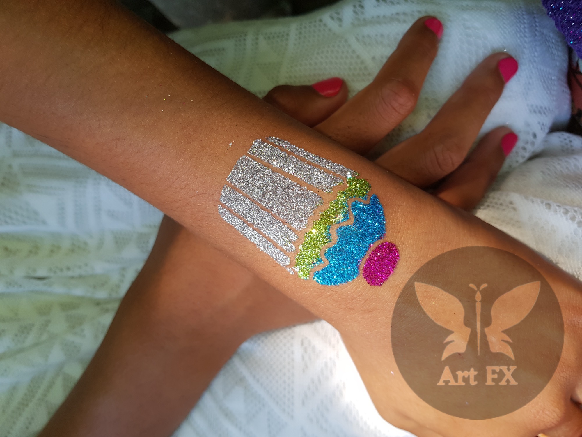 Sparkly glitter tattoo of a cupcake or ice cream with a pink cherry on top.