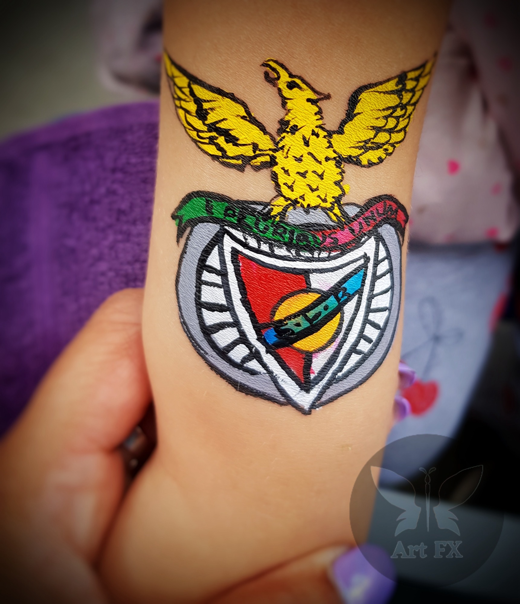 Young girl with a blue and white snowflake crown face painting design with a central unicorn horn