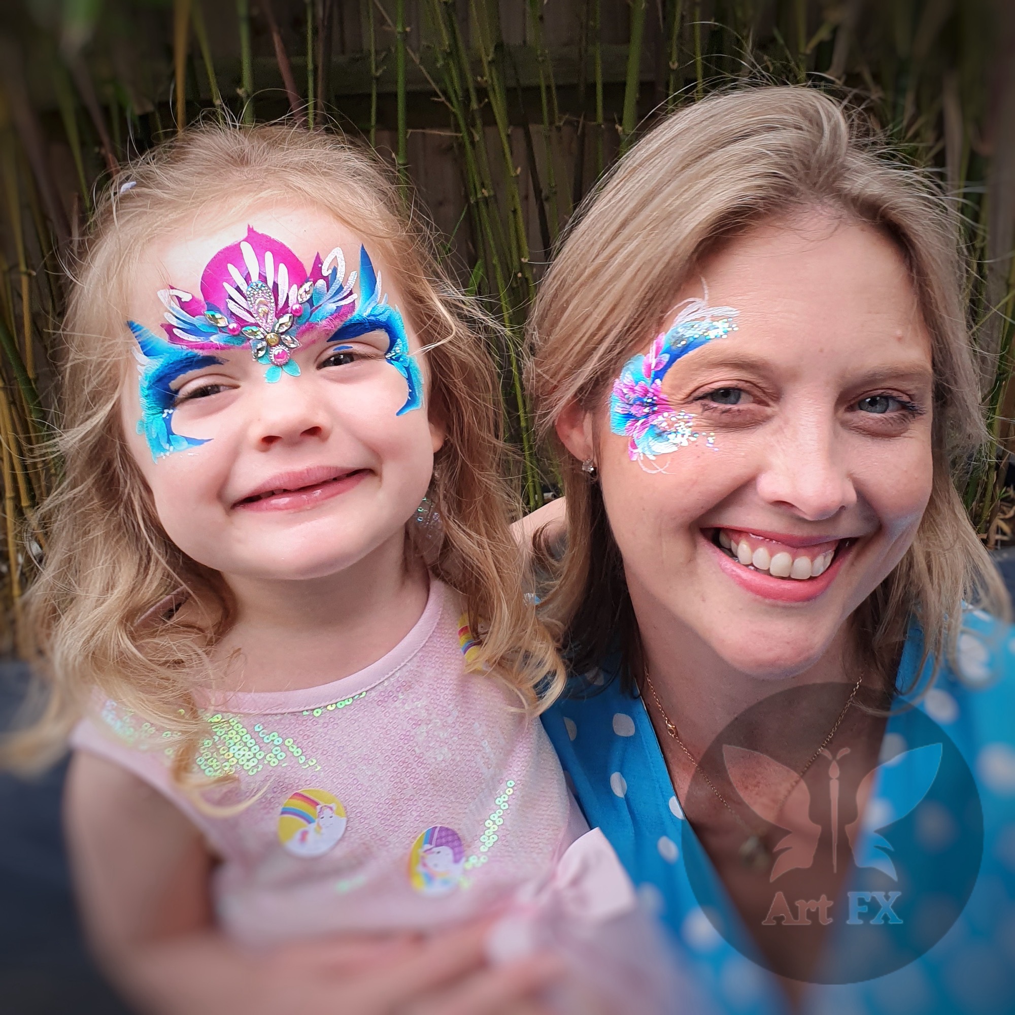 Young boy displaying a metallic red and gold superhero mask face painting design