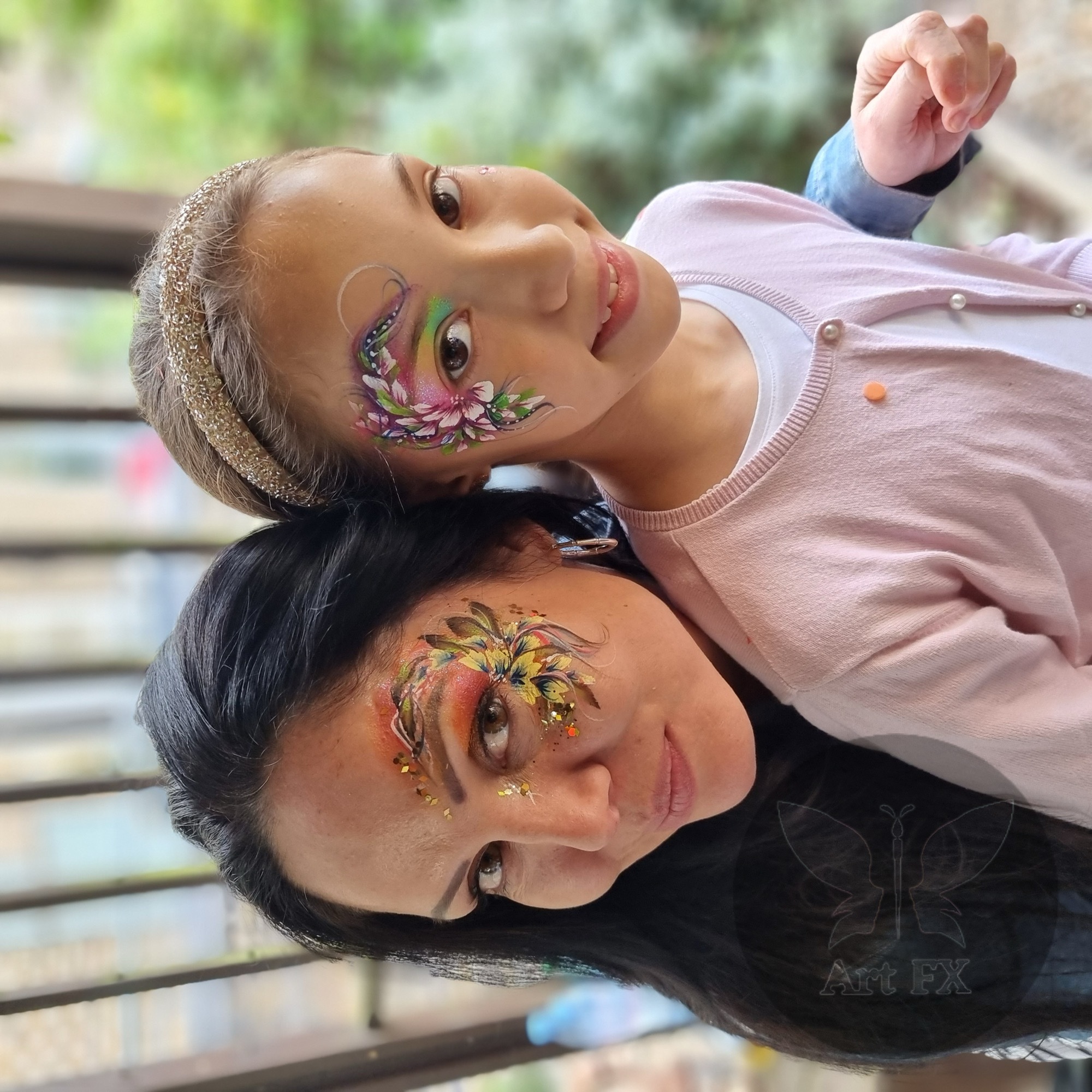 Young boy featuring a vibrant red and black superhero spider web face painting design covering his forehead