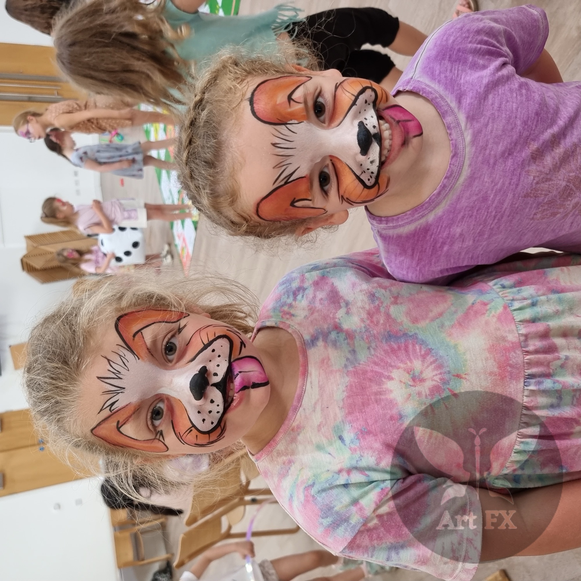 Young boy displaying a colorful red, yellow, and blue comic hero superhero face painting design