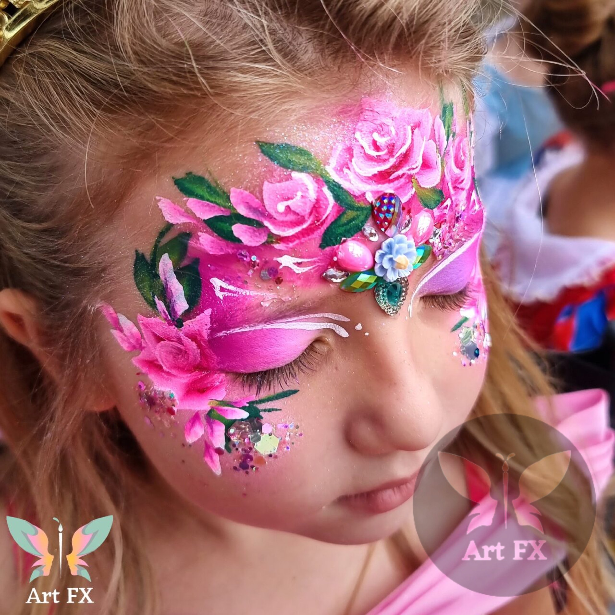 Young child with a cute pink and white floral animal or bunny face painting design