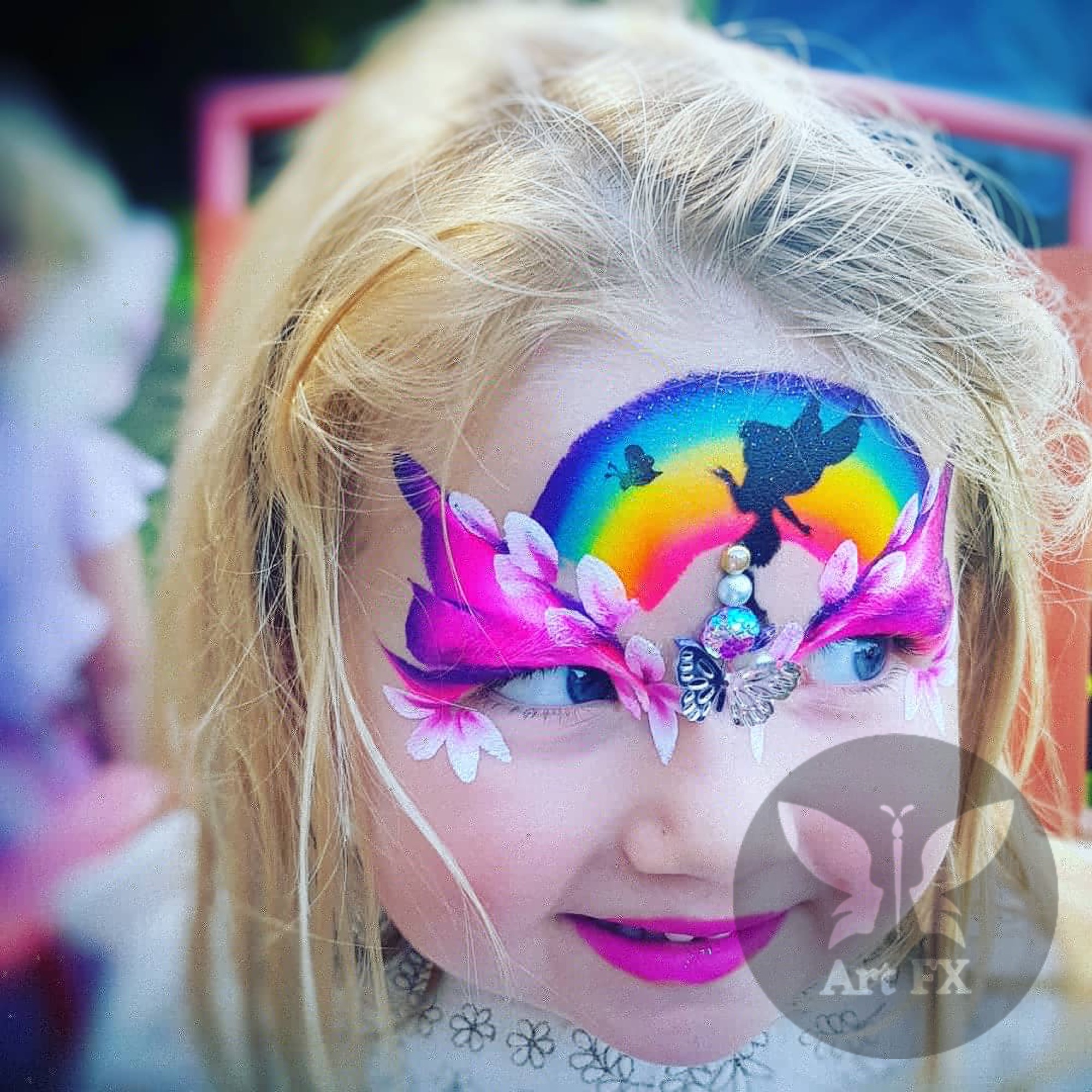 Young boy with a striking green and black hero face painting mask