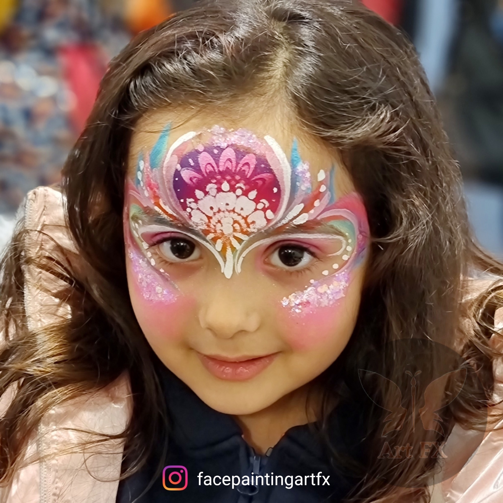 Young boy showcasing a classic red and black spider superhero face painting design