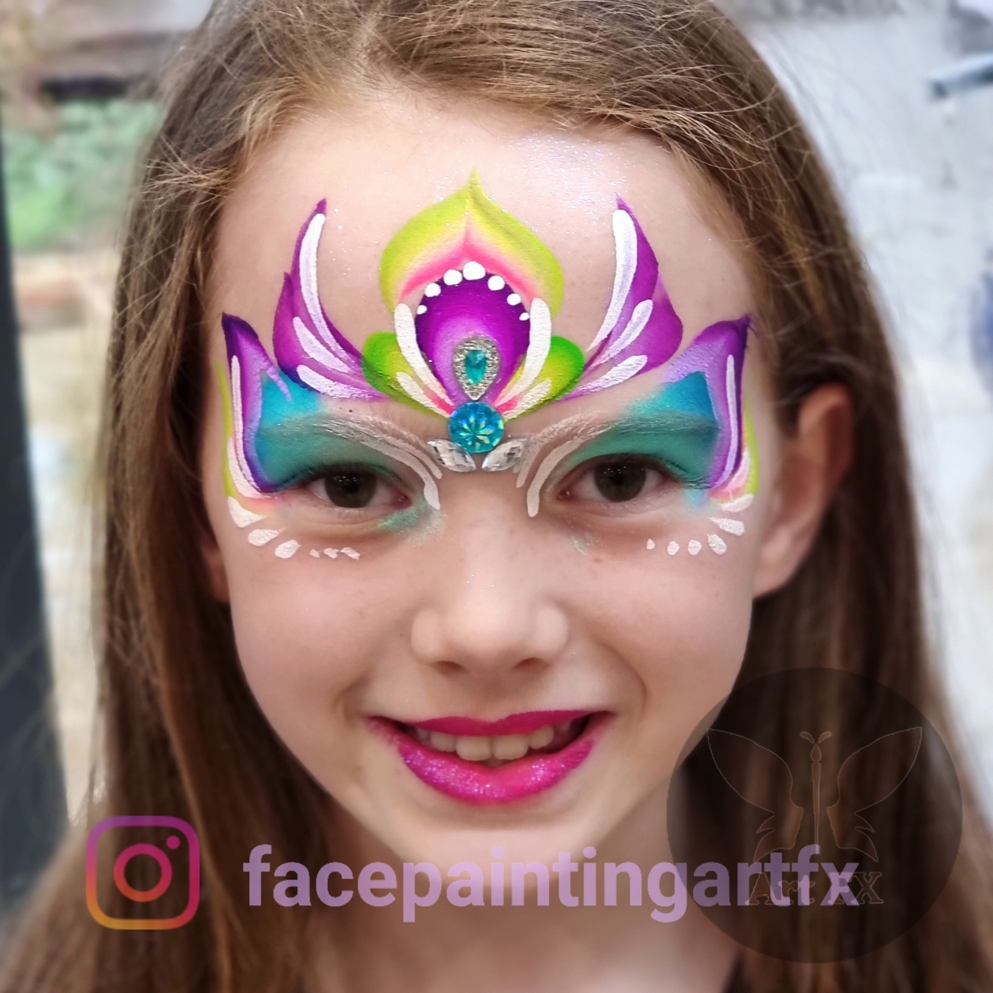 Young boy with a bold dark red and black stealth hero mask face painting design