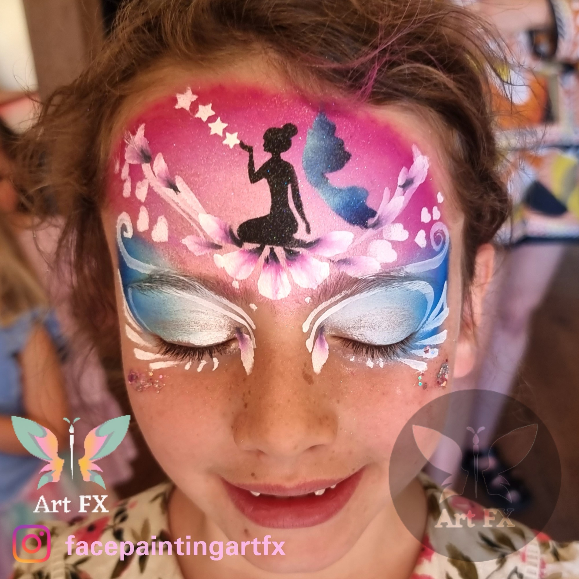Young girl with a magical pink and purple face painting design featuring a black fairy silhouette spreading stardust