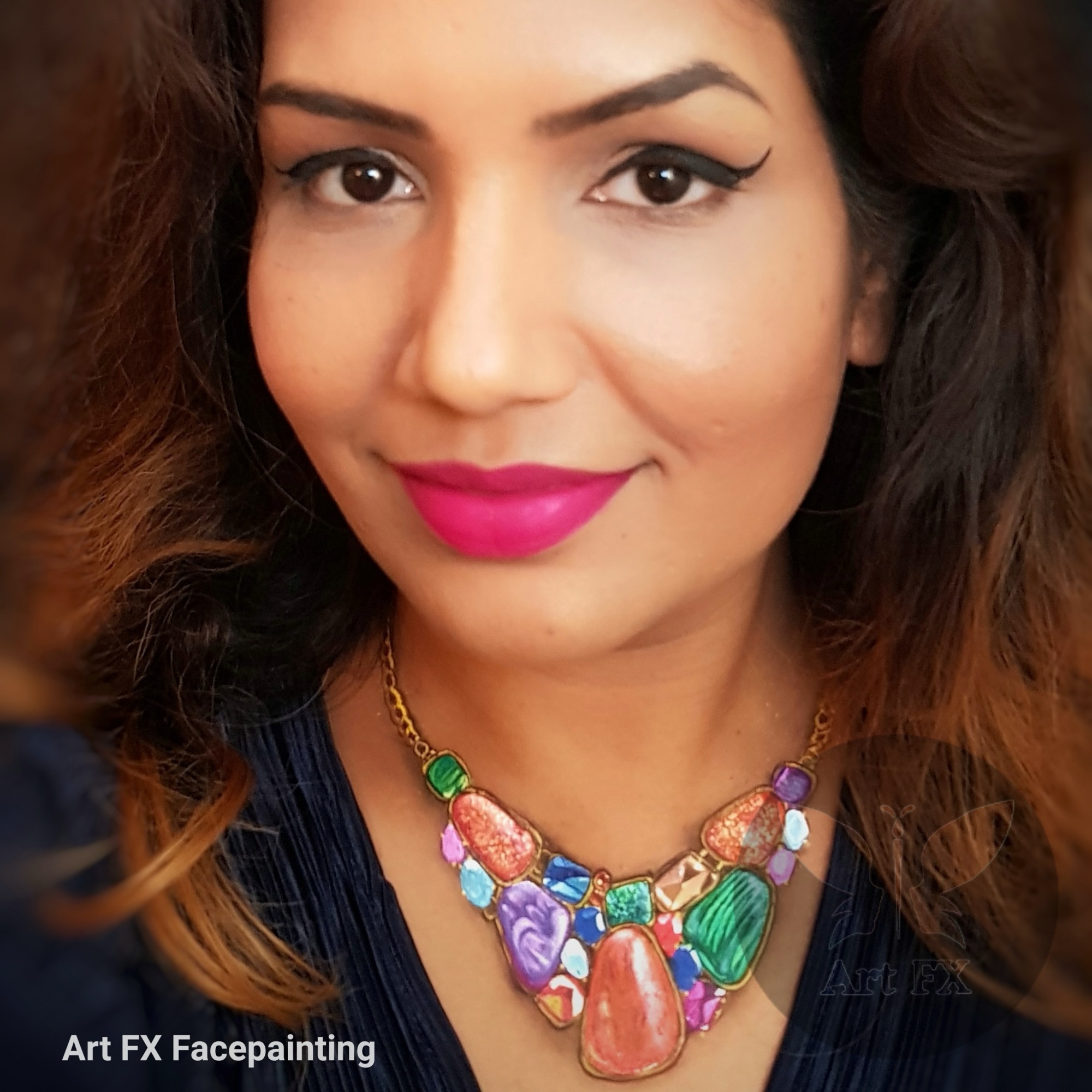 Magical unicorn face paint with a glittery horn and a rainbow mane.