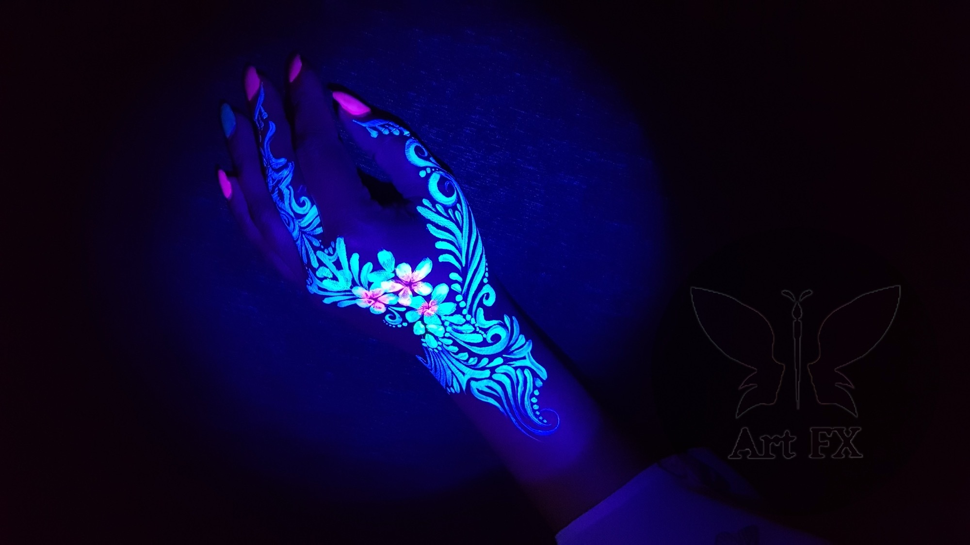 Vibrant neon butterfly face painting design glowing under UV blacklight at a night event