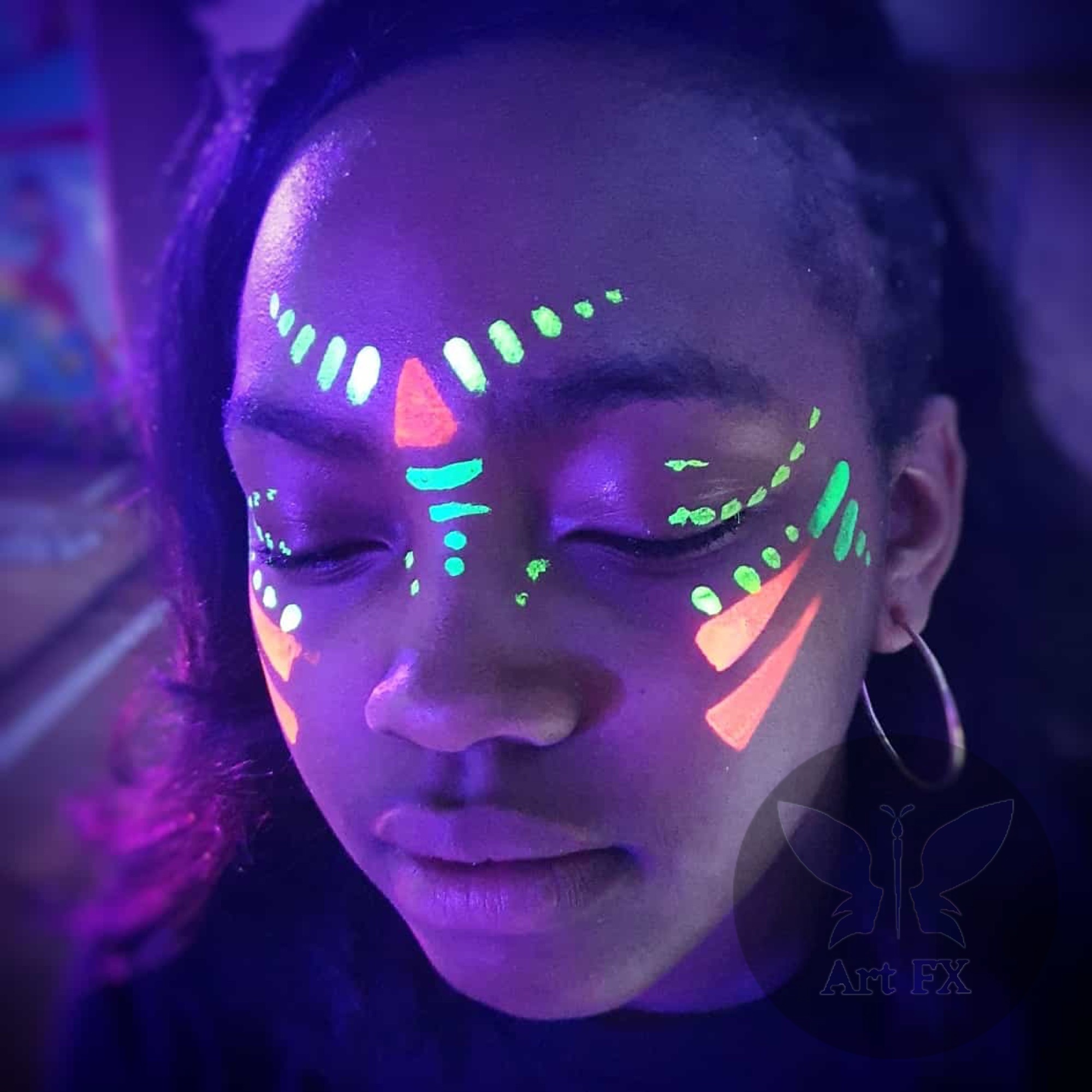 Neon lightning bolt and star face painting design glowing under blacklight at a club event