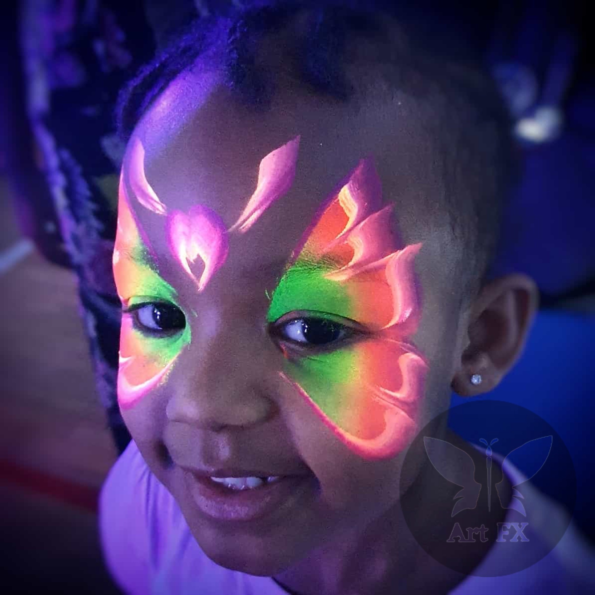Neon abstract geometric face painting design with glowing lines and shapes under blacklight